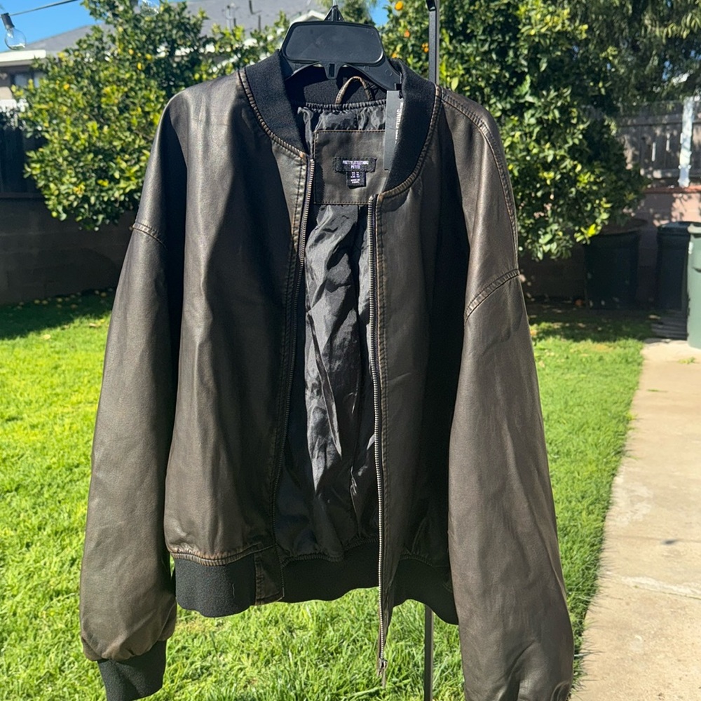 This is a brown women’s bomber jacket